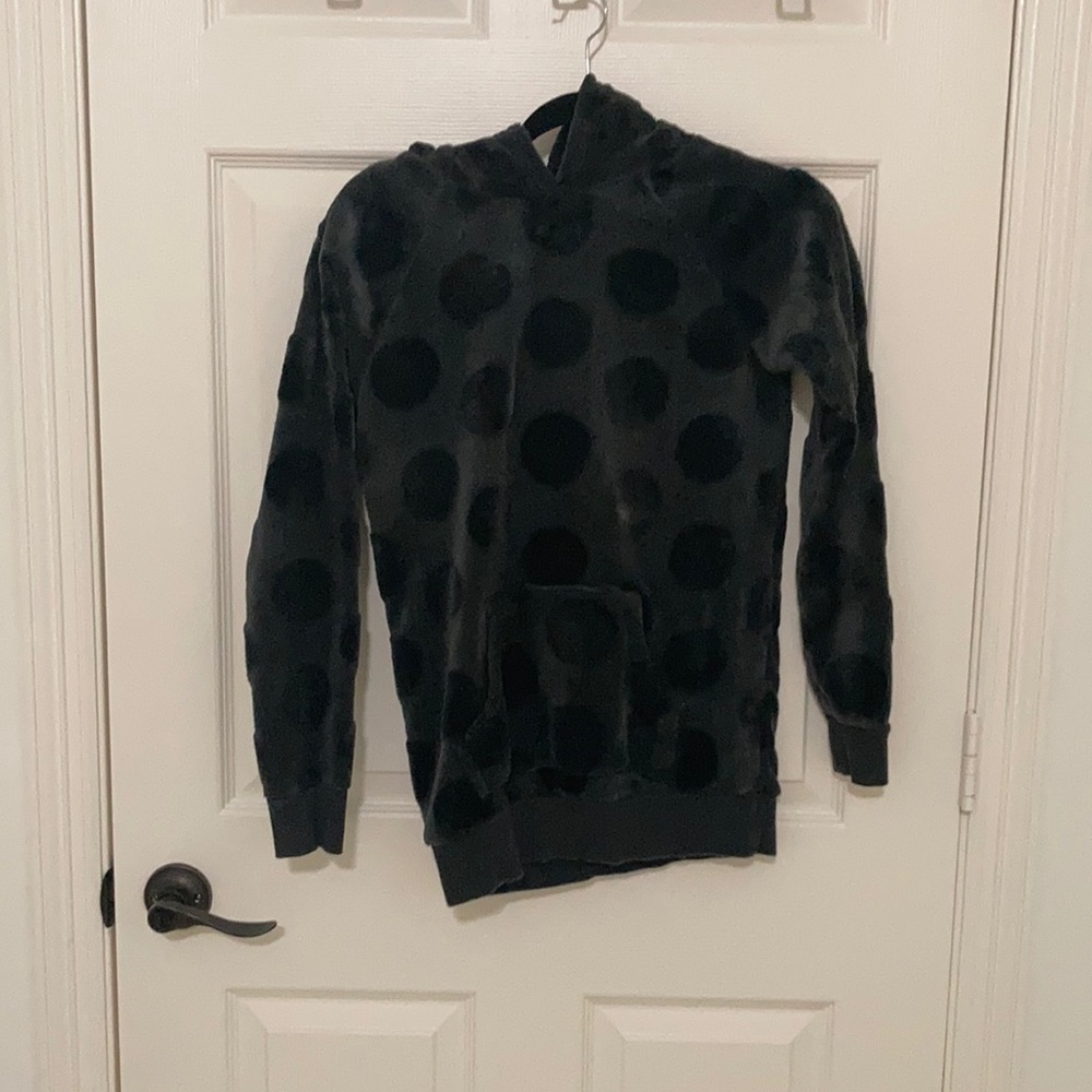 A kids hoodie with cat ears on the hood.